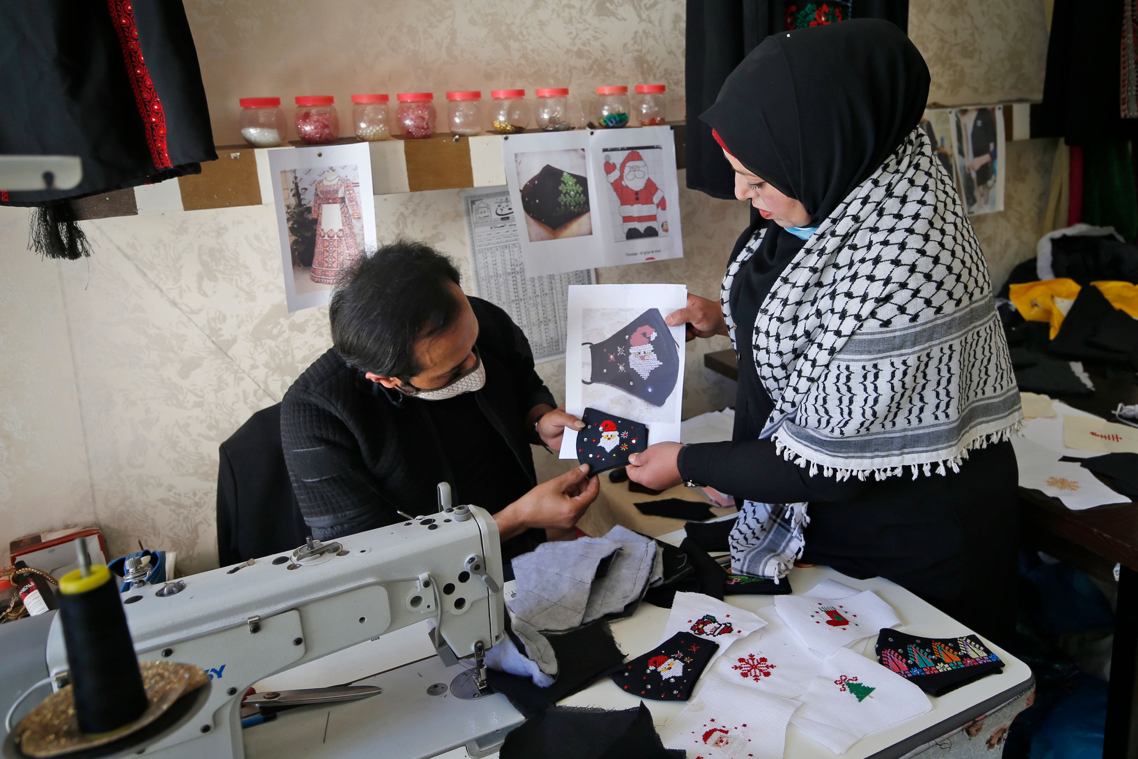Owner of the workshop Suhad Saidam (right) discusses designs (photo: Mohammed Abed/AFP/Getty Images)