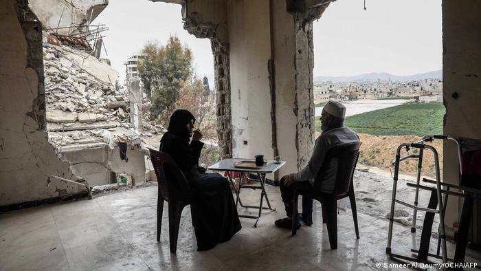Sameer Al-Doumy captures a woman and her husband drinking coffee at home in Douma