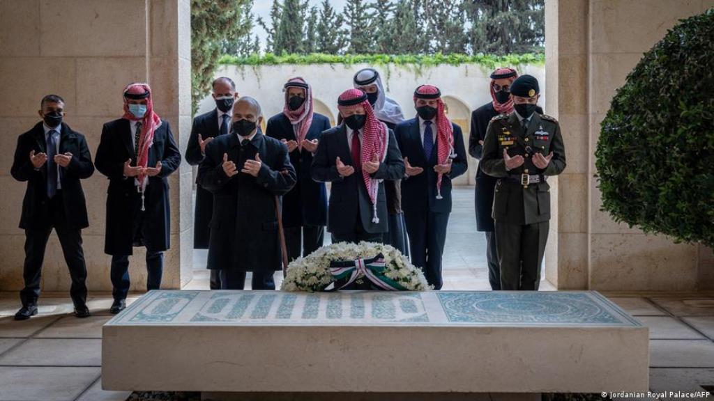 At the grave of their ancestors: Prince Hamzah (second from left) and King Abdullah (just behind the floral decoration) (photo: Jordan Royal Palace/AFP)