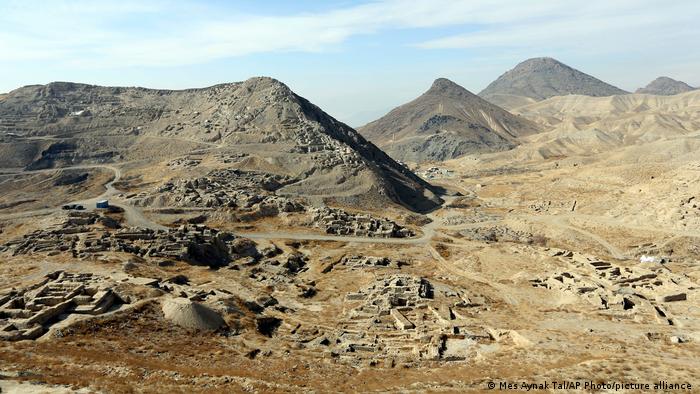 Aerial view of archaelogical site in an arid valley surrounded by bare mountains