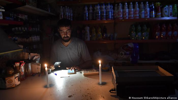 Working at home by candlelight in Lebanon.