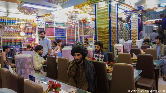 Afghan men are seen in a restaurant in Herat, Afghanistan on 10 September 2021