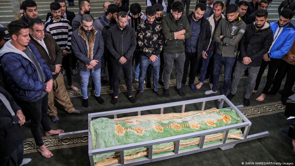 Men in a mosque stand around the repatriated body of Iraqi Kurdish migrant Gailan Diler, who died while trying to illegally cross into Poland via Belarus (photo: SAFIN HAMED/AFP/Getty Images)