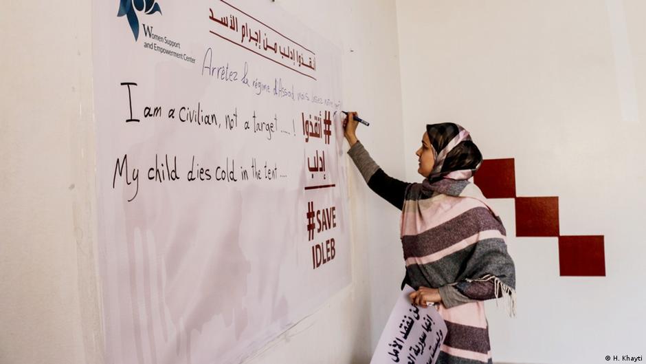 Huda Khayti writes on the whiteboard at Idlib Women's Centre (photo: H. Khayti)