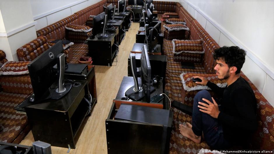 صاحب مقهى إنترنت بمفرده خلال انقطاع الإنترنت على مستوى البلاد في صنعاء، اليمن. An internet cafe owner is seen alone during a nationwide Internet outage in Sanaa, Yemen (photo: picture-alliance/Xinhua)
