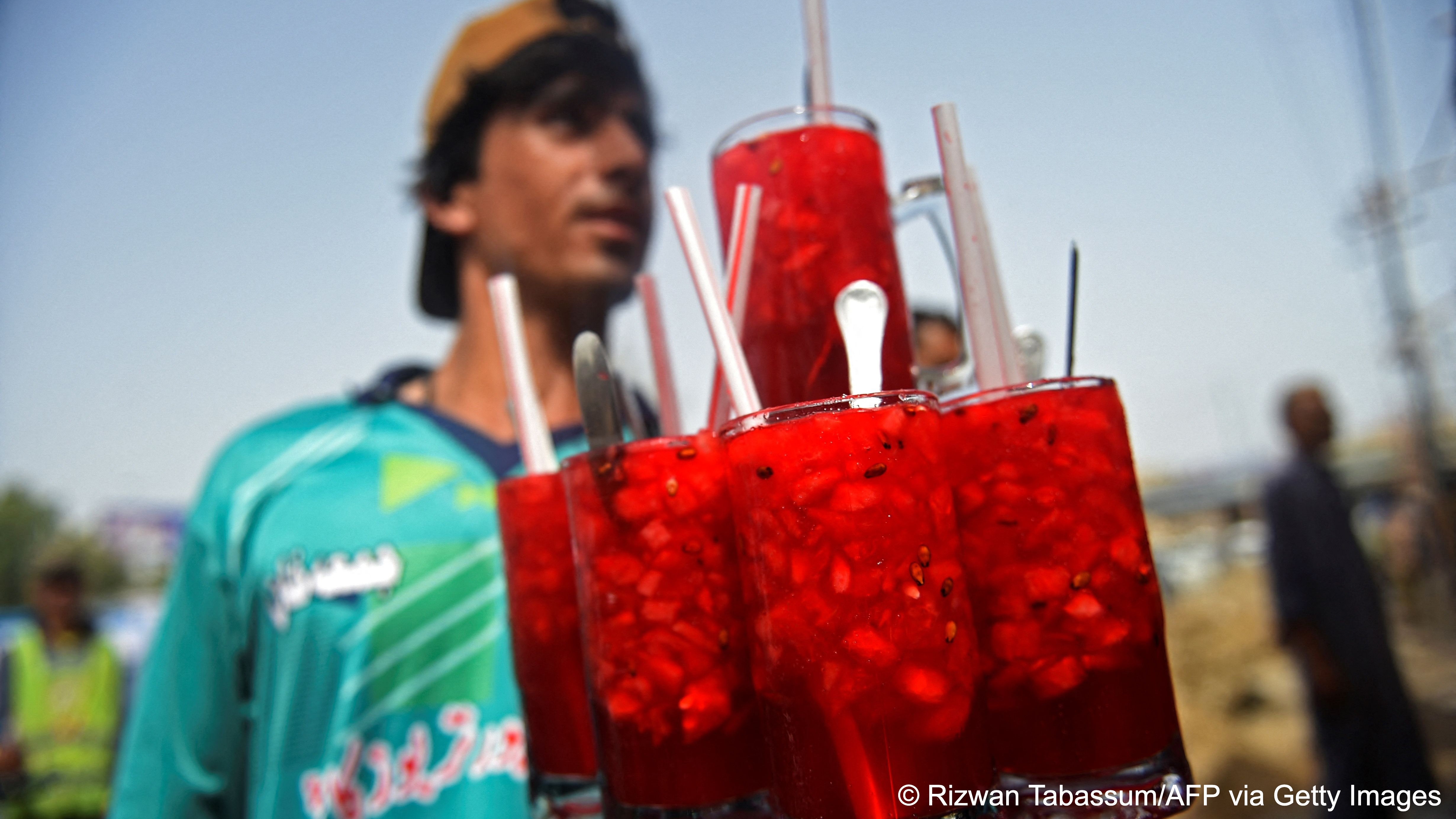 Vendor with a tray of glasses filled with Rooh Afza in Karachi, Pakistan (photo: AFP/Getty Images)