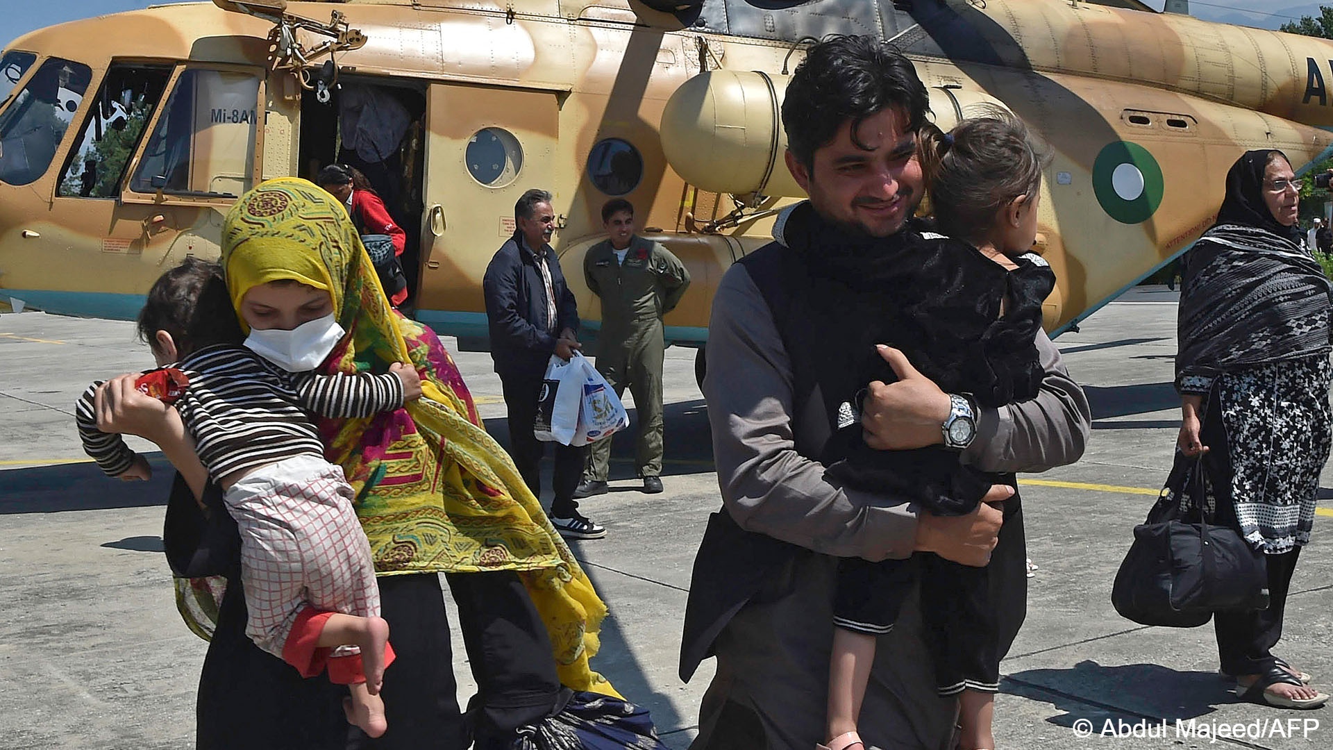 Local tourists disembark from a Pakistani army helicopter after they were rescued from flood-hit tourist areas in the north.