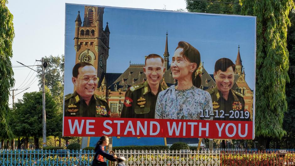 Poster in Yangoon with photo montage of Suu Kyi with Myanmar's generals in front of ICJ building in November 2018 (photo: AFP)