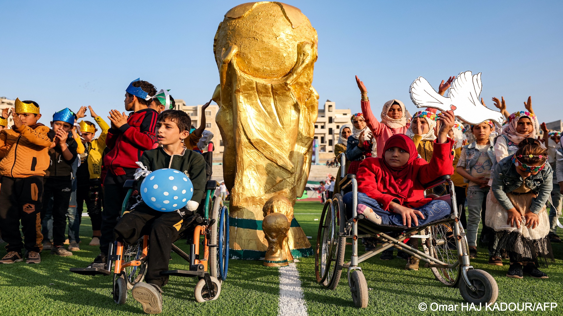 Syrian children take part in the opening ceremony of their own 'camps World Cup' tournament at the municipal stadium in Idlib.