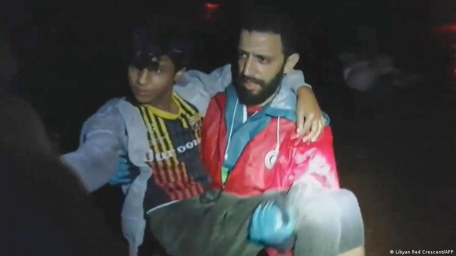 A screen grab shows a rescue worker carrying a boy