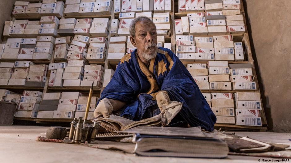 A man sits in one of the rooms where some of the 700 manuscripts privately owned by his family are preserved in Chinguetti,