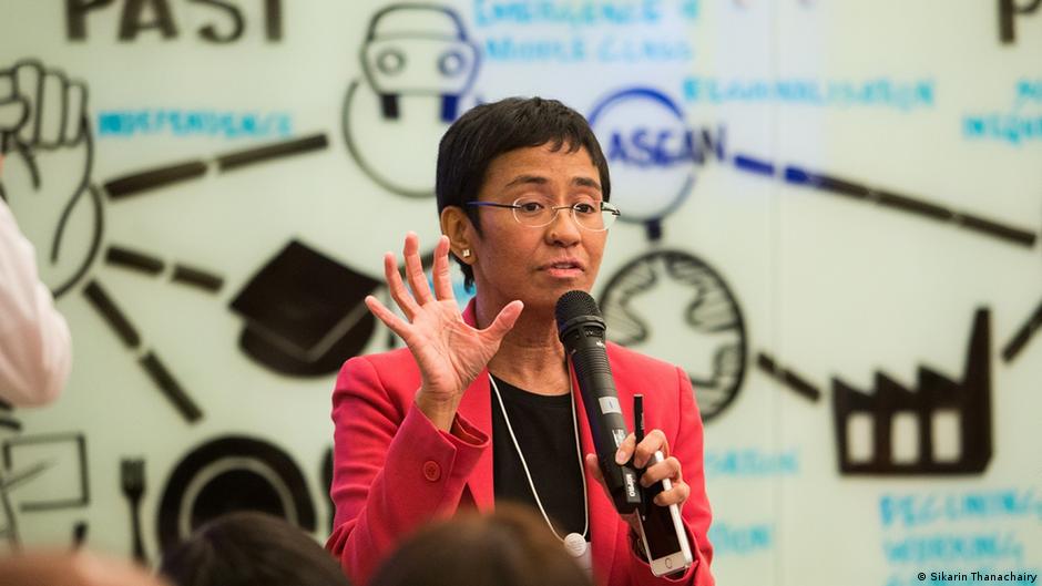 Maria Ressa gesticulating and speaking into a microphone