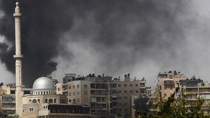 Wads of smoke over the ancient city of Aleppo (photo: Reuters)