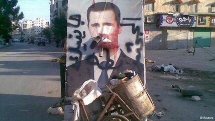 Müllberge vor einem Assad-Plakat; Foto: Reuters