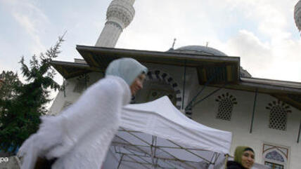 Muslime passieren die Sehitlik Moschee in Berlin; Foto: dpa