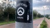 A sticker that says "Defend Europe" attached to a roadside post