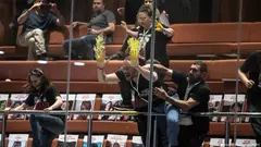 Israeli protesters demand the return of Hamas-held hostages, smearing yellow paint on the windows of Israel's parliament in early April 