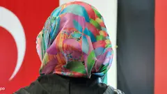 Fotomontage: Frau mit Kopftuch vor deustcher und türkischer Fahne; Foto: dpa